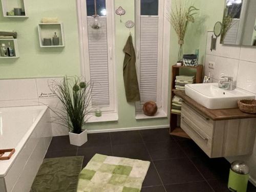 a bathroom with a tub and a sink at Holiday home Sweden house in Kaarßen