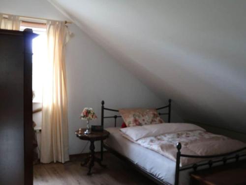 a bedroom with a bed and a table with a window at Holiday home Sweden house in Kaarßen