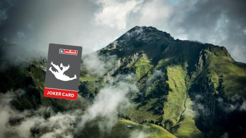 a mountain with a sign in front of it at THOMSN Central Hotel & Appartements in Saalbach-Hinterglemm