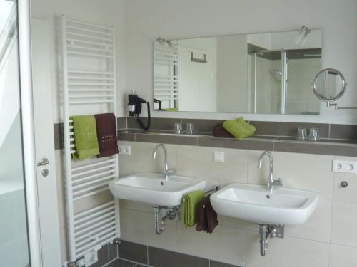 a bathroom with two sinks and a mirror at Holiday home waterfall in Wasserfall