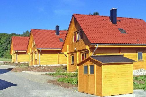 a row of wooden houses with red roofs at Blockhouse Bad Sachsa in Steina
