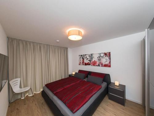 um quarto com uma cama grande e um cobertor vermelho em High Geest 4 - including many extras em Sahlenburg