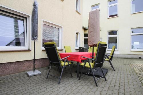 a table and chairs with a red table and a window at Apartment in Malchow with terrace in Malchow