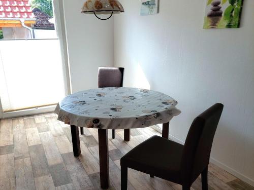 a table and a chair in a room at Holiday Home in idyllic Ziesar near the Natuurpark in Gladau