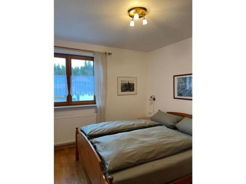 um quarto com uma cama e uma janela em Holiday apartment Finkennest em Eisenbreche