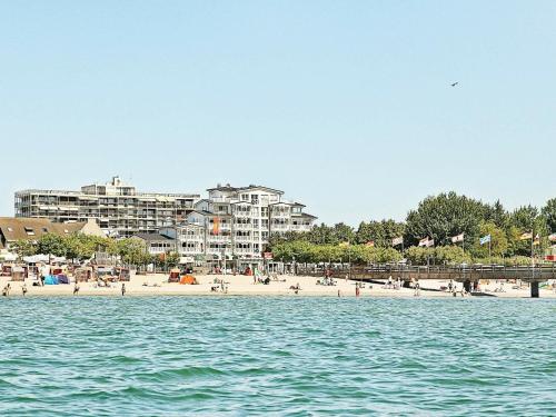 a view of a beach with condos in the background at 6 person holiday home in Gro enbrode in Großenbrode