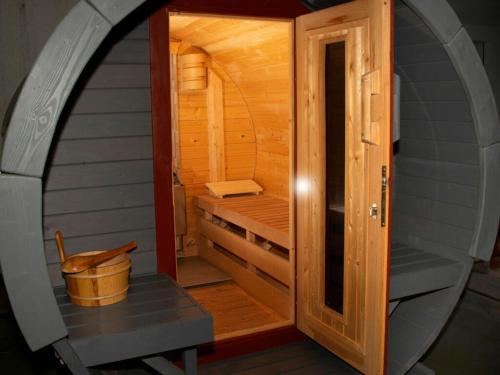 a small sauna with a wooden door and a bench at Rubin - holiday home fores in Burgen