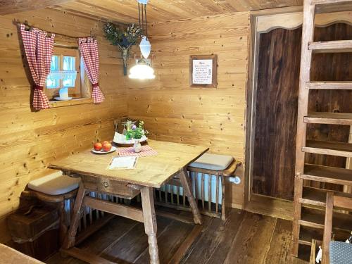 a dining room with a wooden table and chairs at Eco friendly chalet near the lake in Asten in Tittmoning