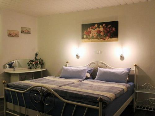 a bedroom with a bed with a painting on the wall at Apartment in Olsberg in Ehrenberg