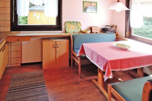a kitchen with a table and a table and chairs at Tennenbronn Holiday Park Tennenbronn in Tennenbronn