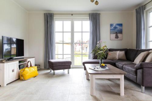 a living room with a couch and a table at Holiday house Fuhlendorf in Fuhlendorf