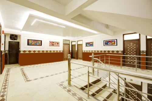 a room with a staircase and paintings on the walls at Hotel Star Villa - Front of New Delhi Railway Station in New Delhi