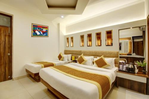 a hotel room with two beds in a room at Hotel Star Villa - Front of New Delhi Railway Station & 5 Minute from Connaught Place in New Delhi