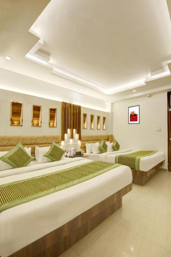 a row of beds in a room at Hotel Star Villa - Front of New Delhi Railway Station & 5 Minute from Connaught Place in New Delhi