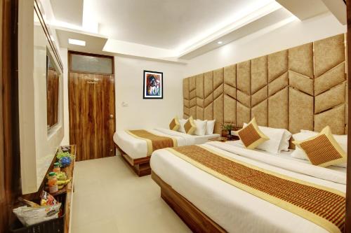 a hotel room with two beds and a wall at Hotel Star Villa - Front of New Delhi Railway Station & 5 Minute from Connaught Place in New Delhi