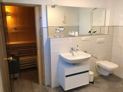 a bathroom with a sink and a toilet at Holiday apartment starfish in Butjadingen