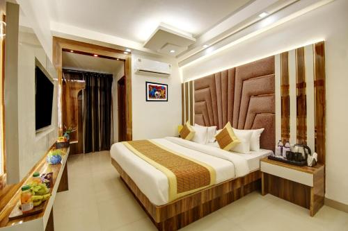 a hotel room with a bed and a television at Hotel Star Villa - Front of New Delhi Railway Station & 5 Minute from Connaught Place in New Delhi