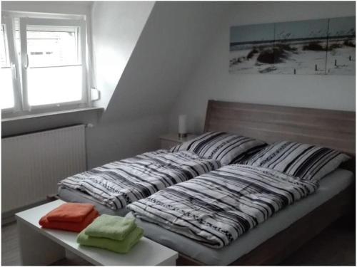 a bed with two pillows on it in a room at Holiday apartment Grohnert in Lübeck