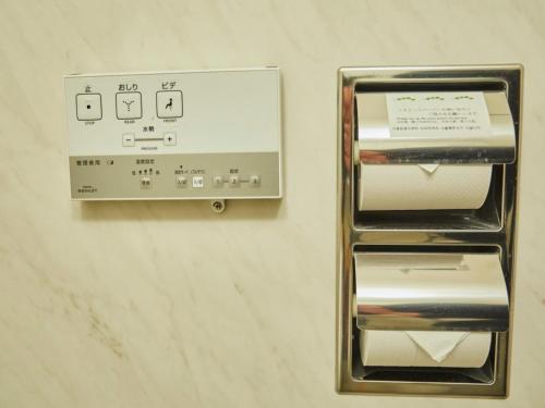 two metal boxes on a wall with a sign at Kansai Airport Washington Hotel in Izumi-Sano