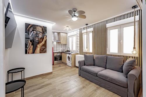 sala de estar con sofá y cocina en Apartamentos Estrecho, en Madrid
