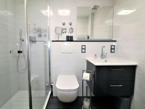 a bathroom with a toilet and a sink and a shower at Nice apartment near beach in Cuxhaven