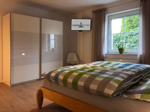 a bedroom with a bed and a window at Holiday apartment DESTINO in Landkern