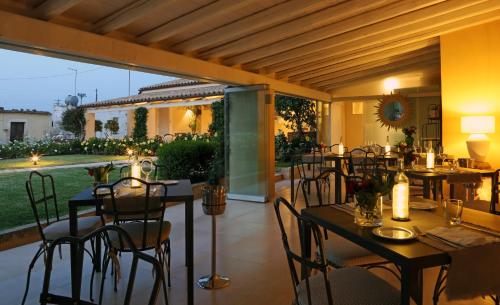un ristorante con tavoli e sedie su un patio di Donna Coraly Country Boutique Hotel a Siracusa