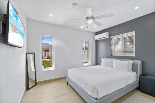 a bedroom with a bed and a ceiling fan at Sabana Liber 12-R in Noord