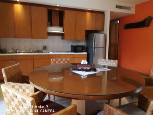 a kitchen with a table and chairs and a refrigerator at Hua Hin Blue Lagoon in Cha Am