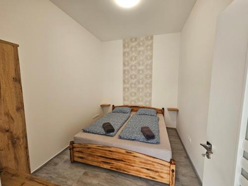 a small bedroom with a wooden bed in a room at Spílerapartman 1 in Balatonalmádi