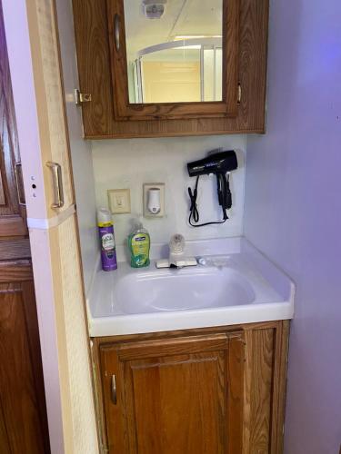 a white sink in a bathroom with a mirror at Romantic getaway in Decatur