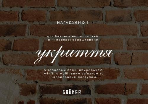 a brick wall with a sign that says feminism at Gruner Hotel in Lviv