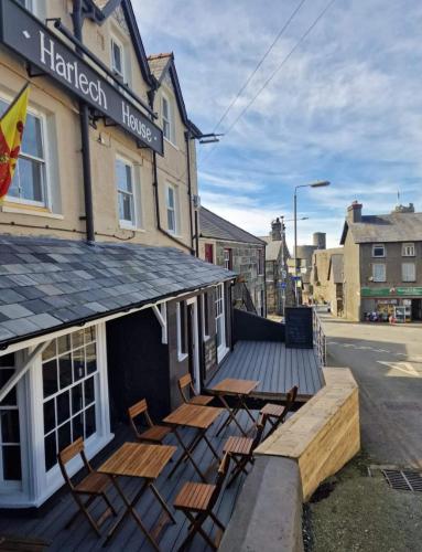 a group of chairs sitting on the front of a building at Harlech House in Harlech