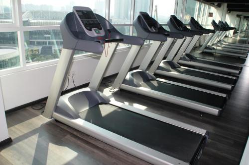 a row of treadmills in a gym at Olive Tree Hotel Penang in Bayan Lepas