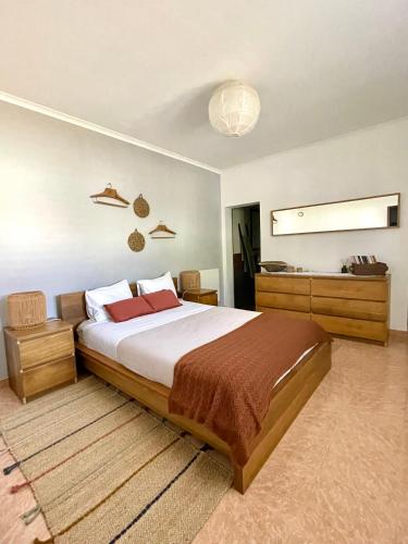 a bedroom with a large bed in a room at Andorinha Levante in Grândola