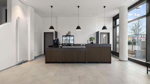 a lobby with a reception desk and large windows at smartments Frankfurt City-Ost in Frankfurt/Main