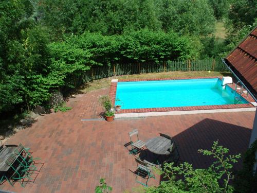 an overhead view of a swimming pool with chairs and an umbrella at Comfortable apartment in quaint holiday village in Barlin