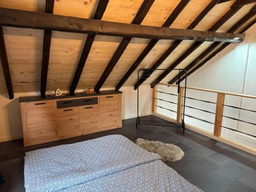 a bedroom with a bed in a room with wooden ceilings at 4711 Suite in Siegburg