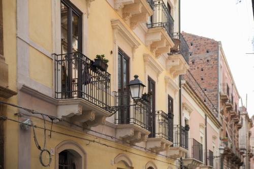 a building with balconies and a street light at SiSTO18 in Catania