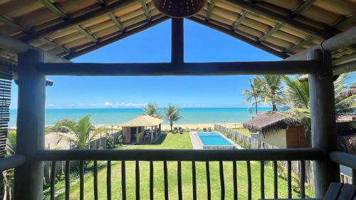 a view of the beach from the balcony of a resort at Bibis house in Porto Seguro