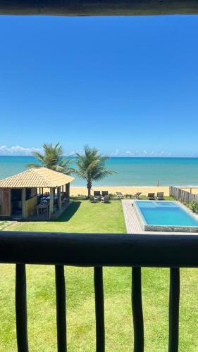 a view of a swimming pool and the beach at Bibis house in Porto Seguro