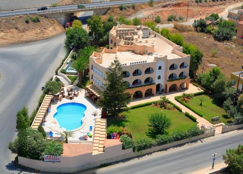 an aerial view of a large house with a swimming pool at Karteros Hotel in Karteros
