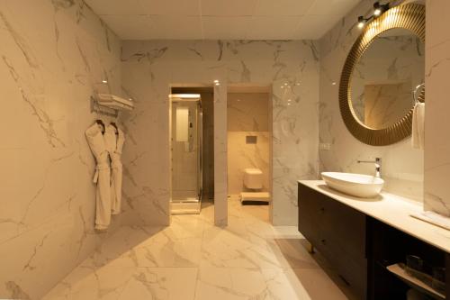a bathroom with a sink and a mirror at The Orchid Shimla in Shimla