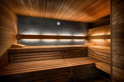 an empty sauna with wooden walls and wooden benches at FAVORITE Parkhotel in Mainz
