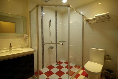 a bathroom with a shower and a toilet and a sink at Maui B&B in Hualien City