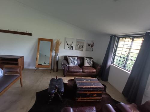 a living room with a couch and a table at Lieu De Grace in Johannesburg