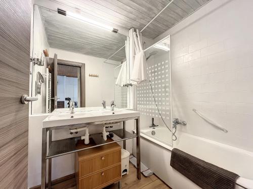 a bathroom with a sink and a shower and a tub at Pied de ladroit - appartement - 4 pers - centre in Les Gets
