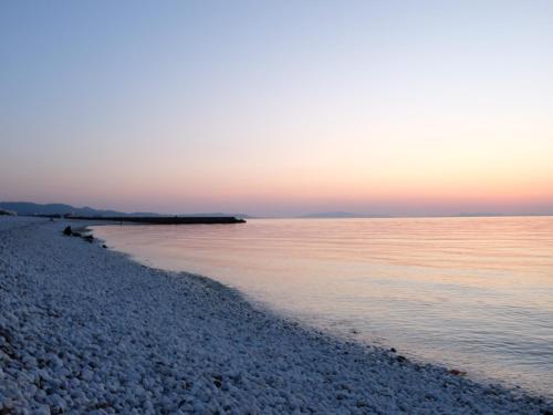 a view of the beach at sunset at EZ HOTEL Kansai Airport Seaside in Izumi-Sano