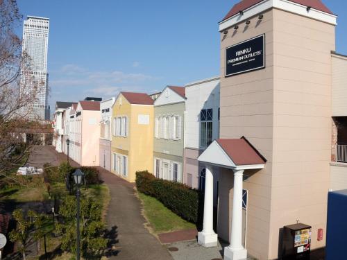 a row of houses with a sign on top of it at EZ HOTEL Kansai Airport Seaside in Izumi-Sano