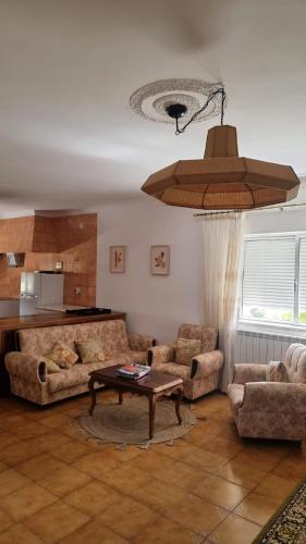 a living room with two couches and a table at Villa Mendes Oliva in Almeida